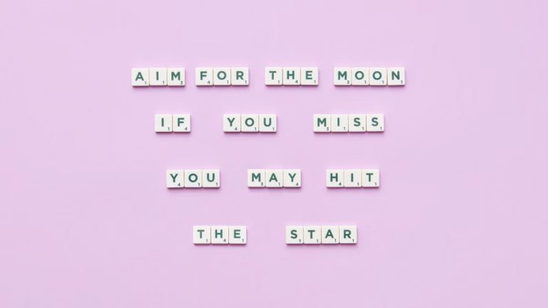 Inspirational message using Scrabble tiles on a pastel background.